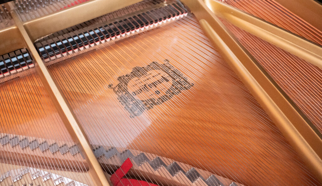 Interior view of Yamaha C7 grand piano strings and hammers in Santa Fe studio